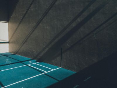 Abstract shadow of a moving athlete on a wall